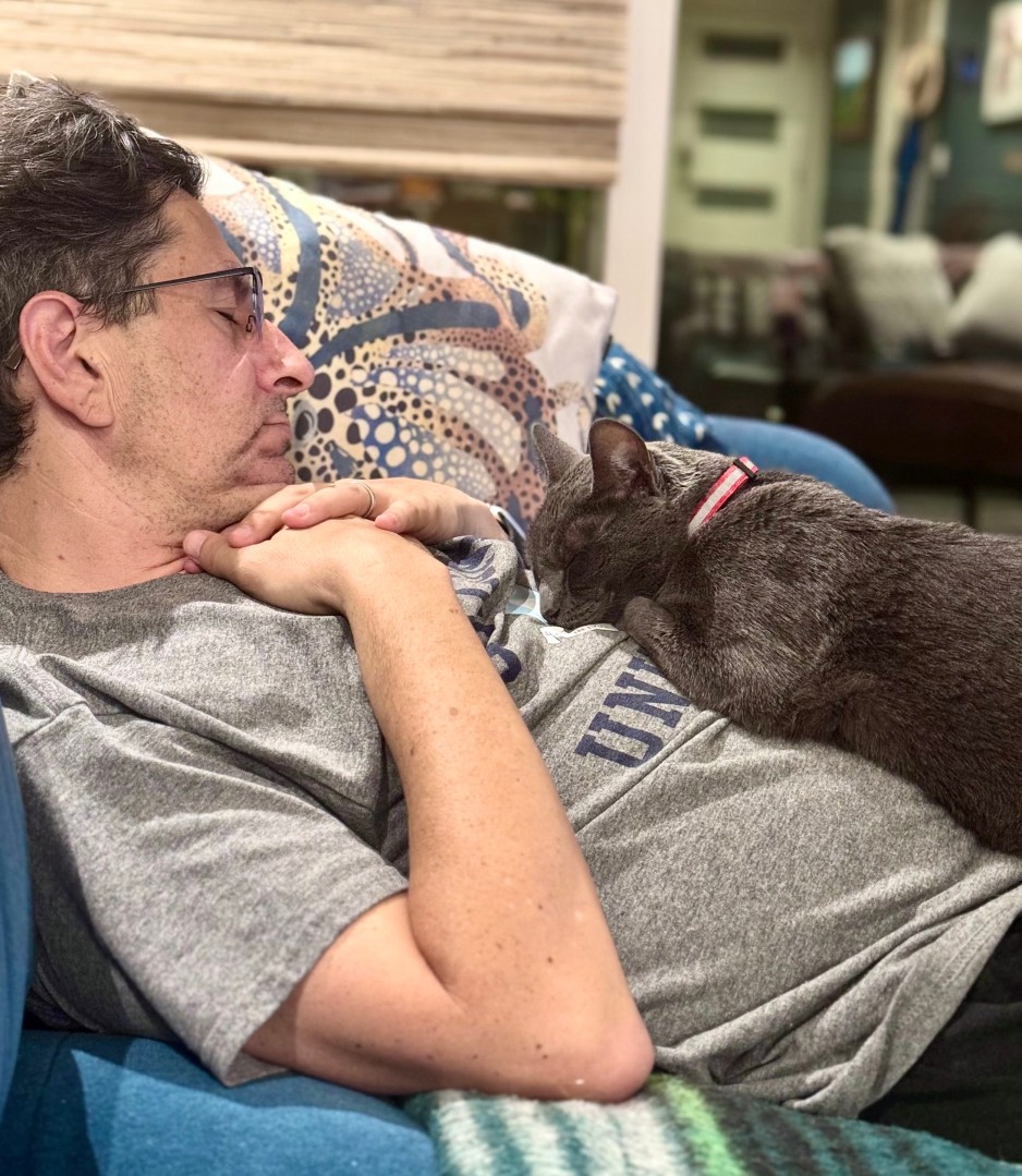 forest sleeping with a cat on his chest